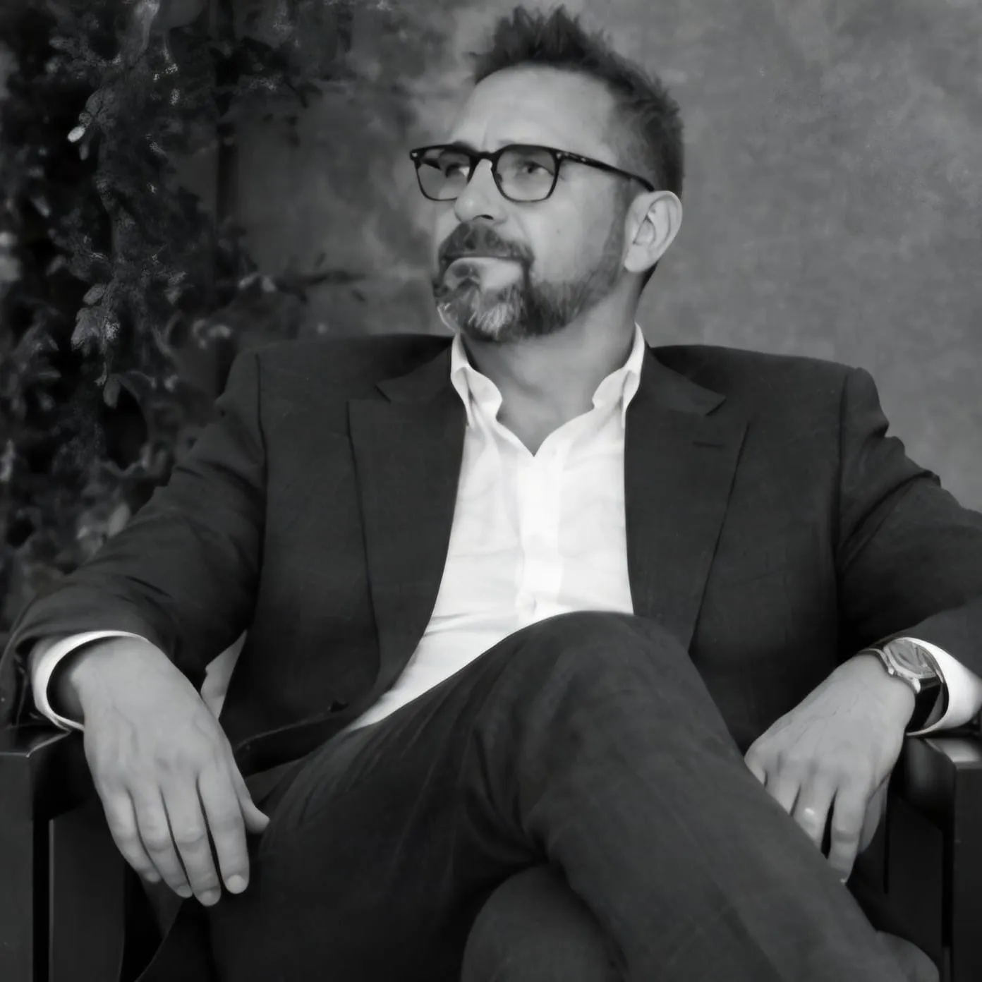 Ariel Levin seated in an armchair, in black and white